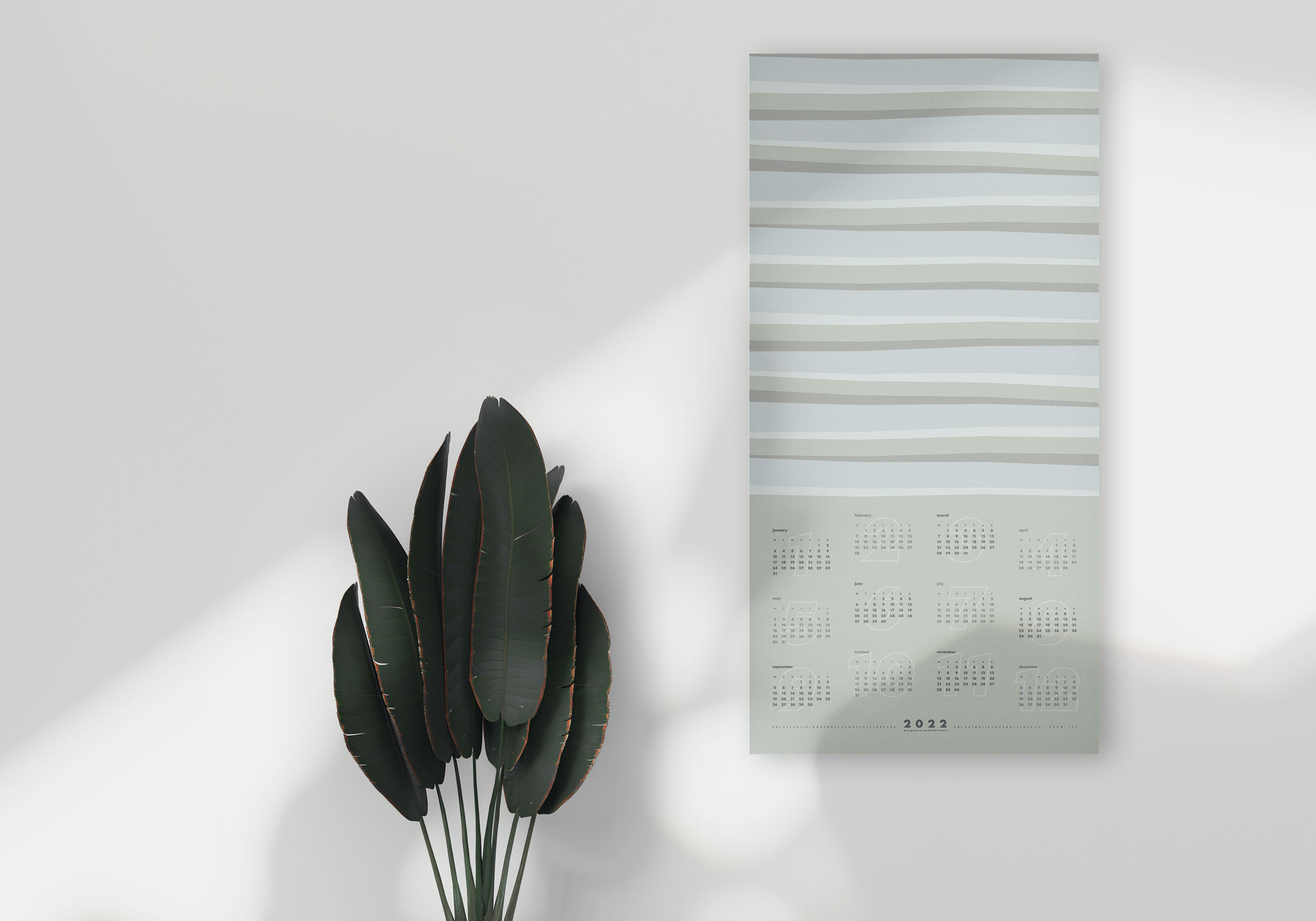 白い部屋で観葉植物と一緒に飾られた2022年アートパネルカレンダーの#Lucidカラー。